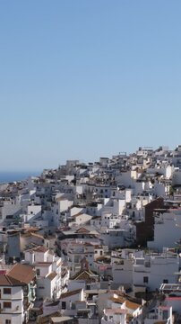 White Houses packed together on a hillside near the ocean, Torrox, Spain