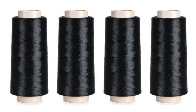 Four spools of black thread are upright, evenly spaced, against a plain white background. The spools are cylindrical with off-white cores. The thread is tightly wound