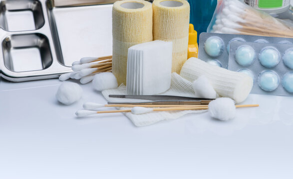 Wound care dressing set. Medical supply for diabetes, surgical and accidental wounds care. Medical equipment for nurse. Forceps, cotton stick, conform bandage, and elastic cohesive retention bandage.