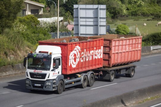 Pontevedra, spain; 04 10 2026 truck transporting skip containers loaded with scrap metal