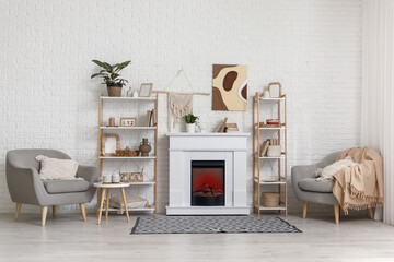 Obraz premium Interior of modern living room with fireplace, shelving units and armchairs