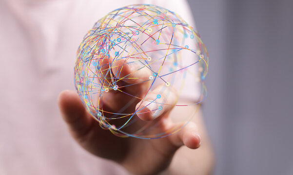 Hand holding a globe with digital lines representing a global network, concept of connection and technology. Ideal for b