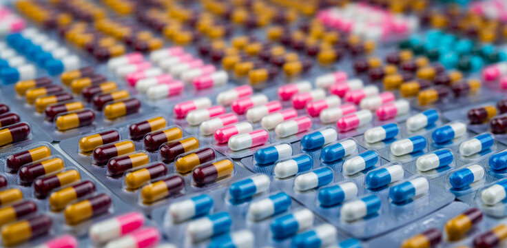 Antibiotic capsule pills in blister pack. Antimicrobial drug production. Prescription medicine. Antibiotic resistance, pharmaceutical industry, infection treatment and global healthcare awareness.