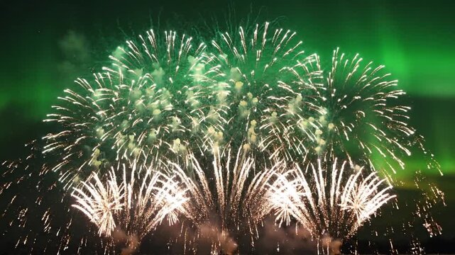 Fireworks Display Lighting Up Night Sky with Bright Explosions and Green Aurora Effect