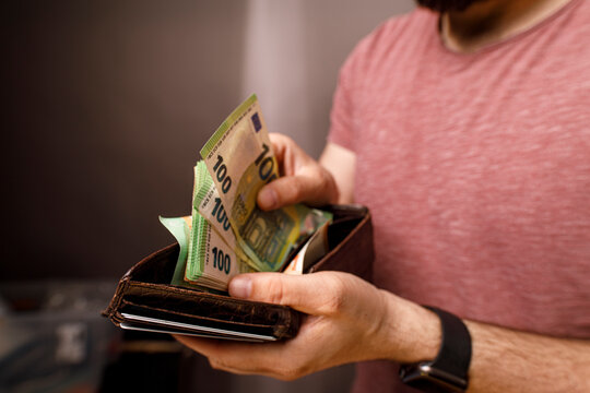 Close up of person holding wallet with money, concept of finance, savings, income and wea