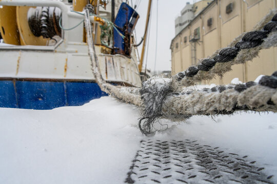 moored fishing trawler during the snowstorm Elli in January 2026