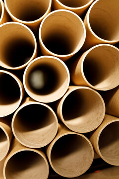 Close up photo of cylindrical cardboard tubes forming a geometric pattern, abstract indus