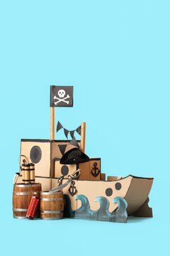 Pirate cardboard ship with explosive on blue background