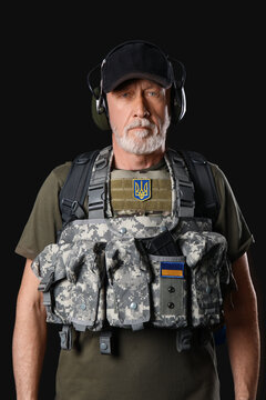 Ukrainian soldier with bag on dark background