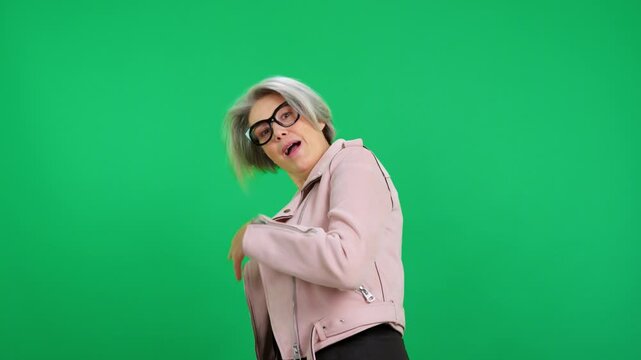 Stylish senior woman inviting to accompany her on green screen background
