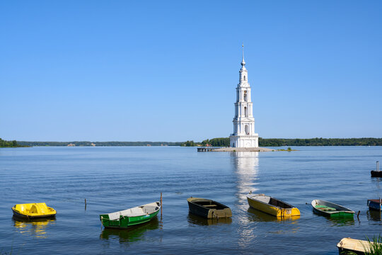 Boats on the banks of the Volga River with a view of the bell tower of St. Nicholas Cathedral (built in 1800), which remained after the flooding of the cathedral