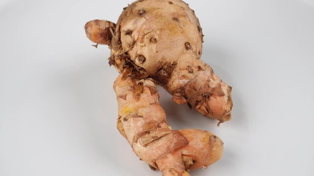 Rotating Javanese Turmeric or Curcuma zanthorrhiza Isolated on White Background for Traditional Herbal Remedy Concepts