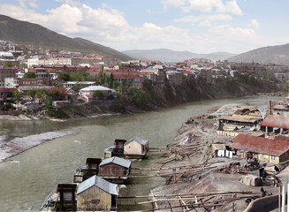 Hand-colorized panoramic view of Old Tbilisi and Mtkvari River with traditional water mills, Georgia – authentic early 20th century cityscape (NOT AI generated) © tornike