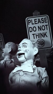 A group of faceless spinning mannequins and political statements contained on street signs on an endless loop.
