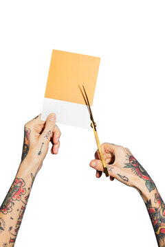 Tattooed hands cutting a yellow paper transparent png