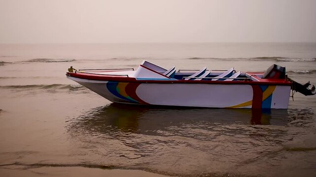 A morning coastal video footage taken at Digha Beach, India, featuring a single-hull fibreglass boat swaying in the gentle waves beneath a soft, hazy sky. Ideal themes for travel, tourism, and nature.