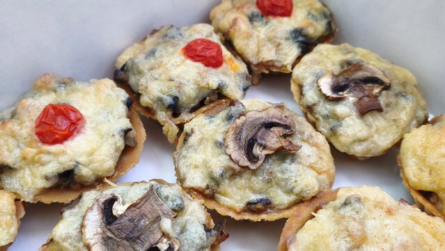 Freshly made sandwiches stacked on a counter in a busy deli. Fresh food to take away. Holiday, cakes with gpibs, cheese filling, vegetables. Homemade food to order