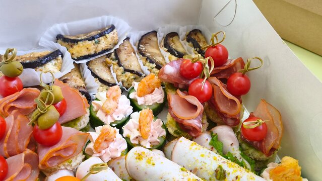 Freshly made sandwiches stacked on a counter in a busy deli. Fresh food to take away.  Homemade food to order