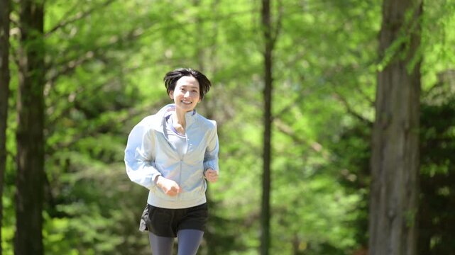 A video showcasing a healthy lifestyle featuring women doing aerobic exercise and running in a refreshing outdoor park with fresh spring foliage, evoking a spring and summer vibe