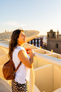 Travel: Woman enjoys the view from Metropol Parasol, la Setas, Seville, Spain, experiencing the city's architecture and culture, a lifestyle concept.