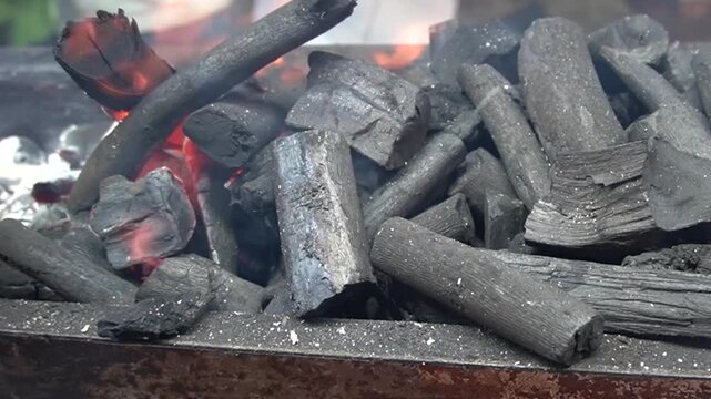 Glowing charcoal embers creating warm, rustic cooking atmosphere, heat energy concept