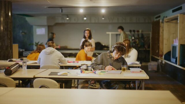 Young students are actively learning and collaborating in a modern classroom. This dynamic setting showcases youth engagement in educational activities.