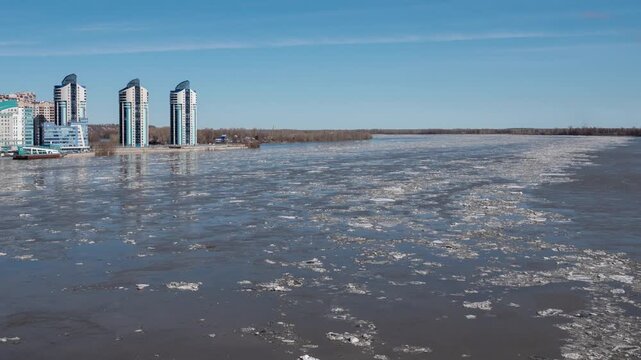 April 09 2026 Barnaul Russia timelapse of ice drift on river floating ice floes blue sky with white clouds spring thaw.