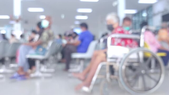 Blurred hospital waiting area with patients and a wheelchair, representing healthcare, waiting, treatment, and medical environment