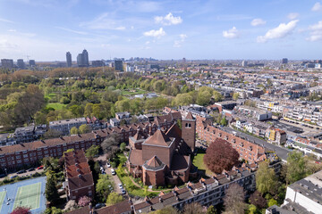 Naklejka premium Aerial urban of residential neighbourhood Watergraafsmeer in Amsterdam, The Netherlands with Hofkerk church square in the middle of the low housing quadrant. Dutch housing real estate investment ma