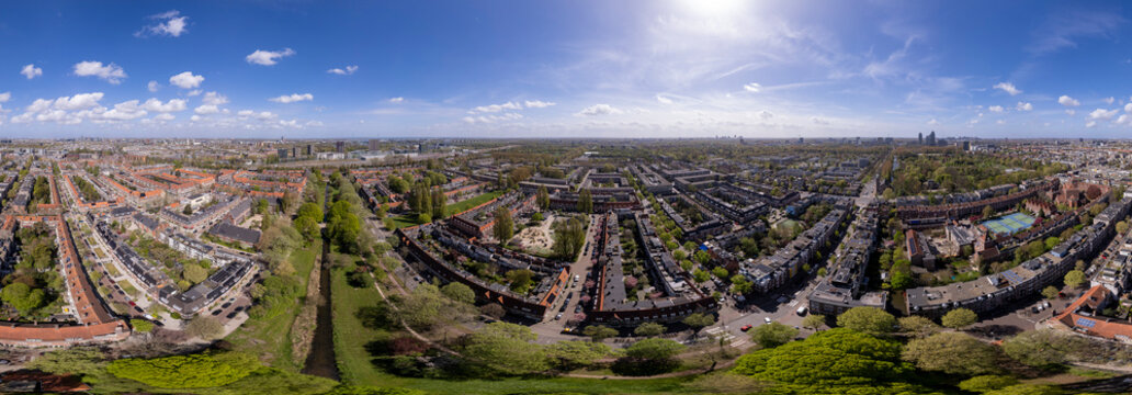Wide 180 degrees aerial of residential neighbourhood Watergraafsmeer in Amsterdam, The Netherlands with Hofkerk church square in the middle of the low housing quadrant. Dutch housing real estate inves