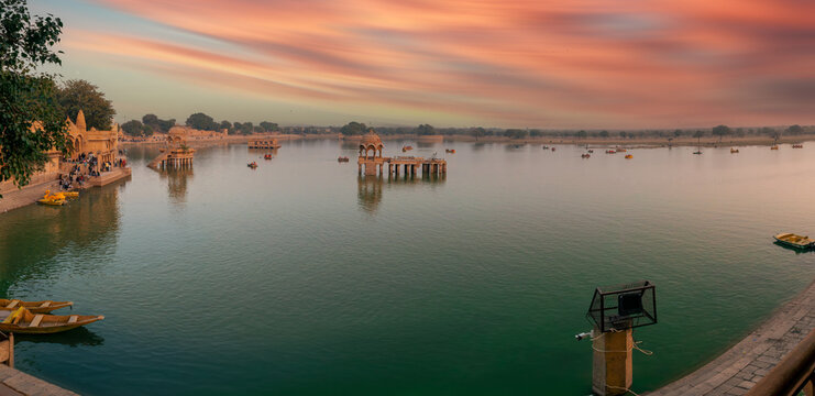Wide Panorama of Gadisar Lake at Sunset with Ancient Chhatris and Sandstone Architecture, Jaisalmer, Rajasthan, India