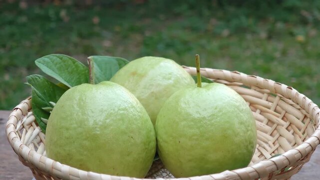 Pink-fleshed guavas in a bamboo basket.