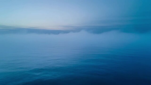 IMAX Macro of Soft Grey-Blue Fog Blanket Hovering Over Still Ocean at Dawn 4K