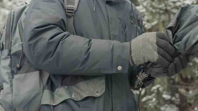 Individual carefully sets umbrella structure. Someone meticulously manipulates umbrella ribs and fabric. An individual attentively adjusts framework and fabric of compact umbrella with care