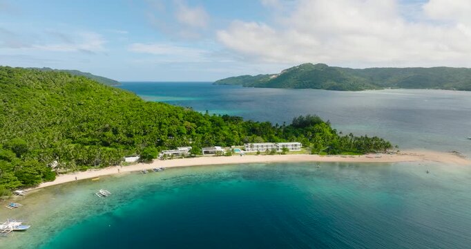 Panorama view of beach resort with boats floating over clear water in Logbon Island. Romblon, Philippines.