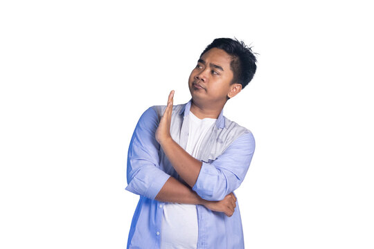 Disapproving Asian man making stop gesture, looking sideways. white background
