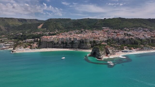 Aerial orbit around Tropea bay and cliffside town, Calabria coast, Italy
