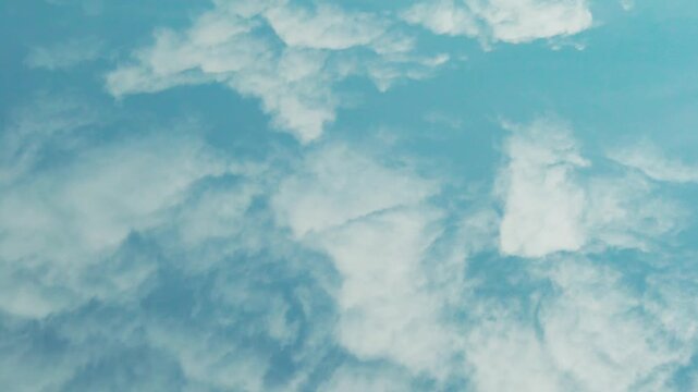 Daytime air plane window view azure sky white puffy fluffy cotton clouds sun aerial drone view, time lapse. Amazing summer skyscraper and cloud 4K . 