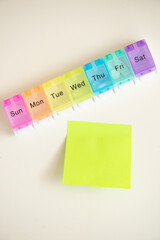 A daily pill dispenser, medical equipment, sticker without inscription on a white background. © Natalia