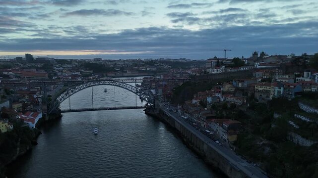 Aerial view of the Dom Lu&iacute;s I Bridge spanning the Douro River, a blend of architectural elegance and industrial prowess, Porto, Portugal.
