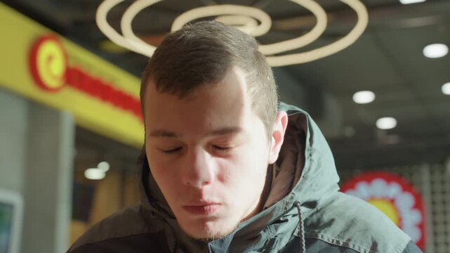 Content man enjoying coffee. Man displays cheerful smile at cafe. Man with joyful expression in cozy cafe setting. Relaxed man showing pleased smile amidst warm cafe ambiance and cityscape