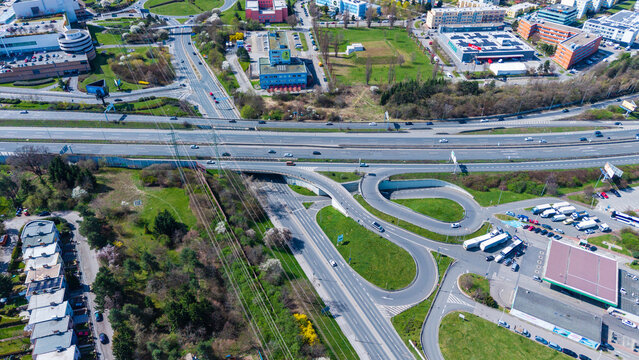Aerial view of the intertwined roads and highways cutting through a vibrant landscape, contrasting urban development with natural green spaces, Prague, Prague, Czechia.