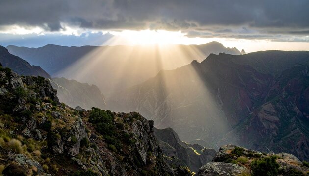 Mountain range with sun rays and clouds