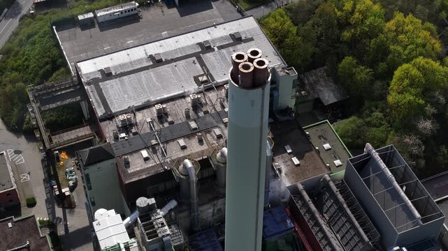Aerial view of industrial plant chimney emitting white steam