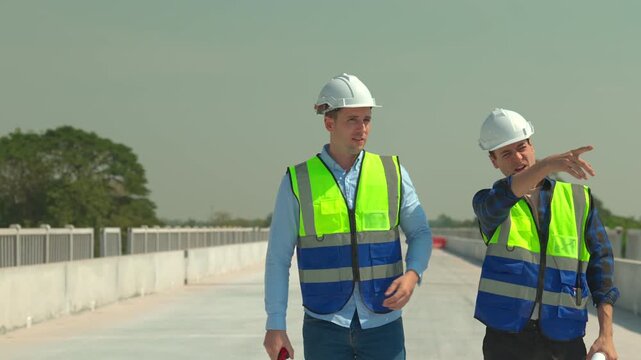 Construction worker safety helmet vest engineer inspection bridge roadway infrastructure outdoors teamwork planning project site hard hat high visibility blue shirt walkway roadway bridge safety