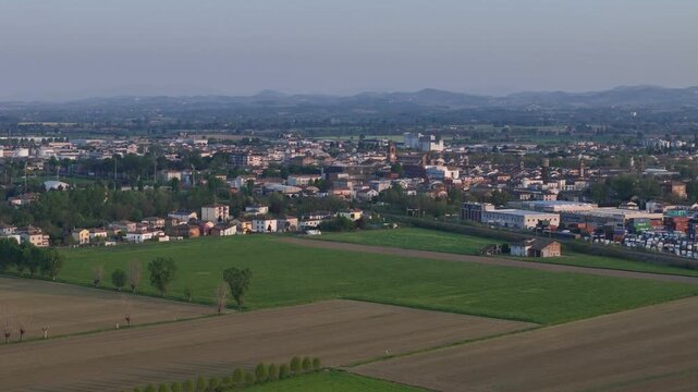 Fiorenzuola d Arda in Piacenza Province Emilia Romagna Italy with town skyline featuring the Collegiata di San Fiorenzo church tower and distant Northern Apennines on the horizon within Po Valley