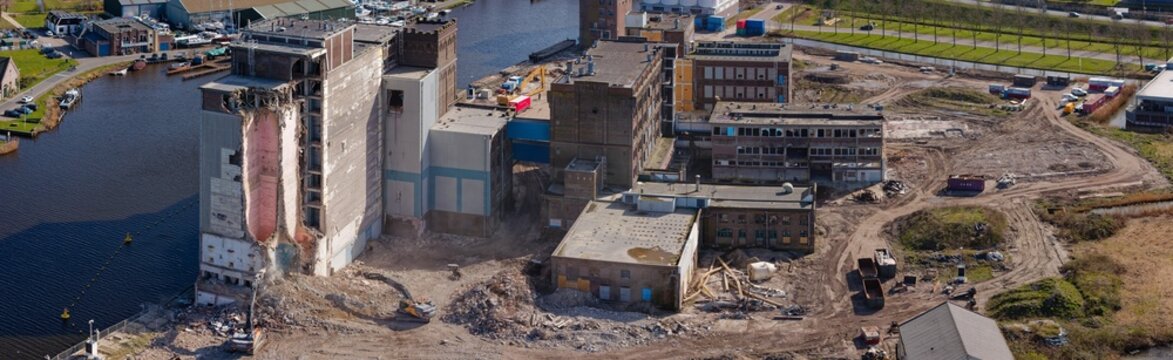 Aerial view of the skeletal remains of the Meneba Flour Mill stand against the skyline during its demolition, Wormerveer, Netherlands.