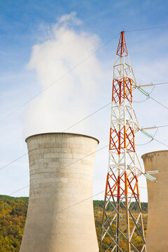 Geothermal power plant in tuscany hills with electricity pylon (Italy)