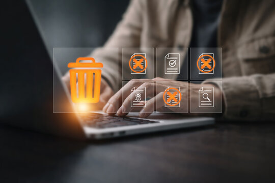 Data management concept with hand deleting digital files and documents showing data cleanup, file removal, privacy protection, information management and secure document disposal business technology.