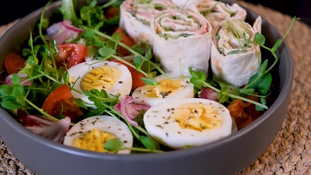 Low carb healthy bowl with tuna wraps fresh vegetables and eggs